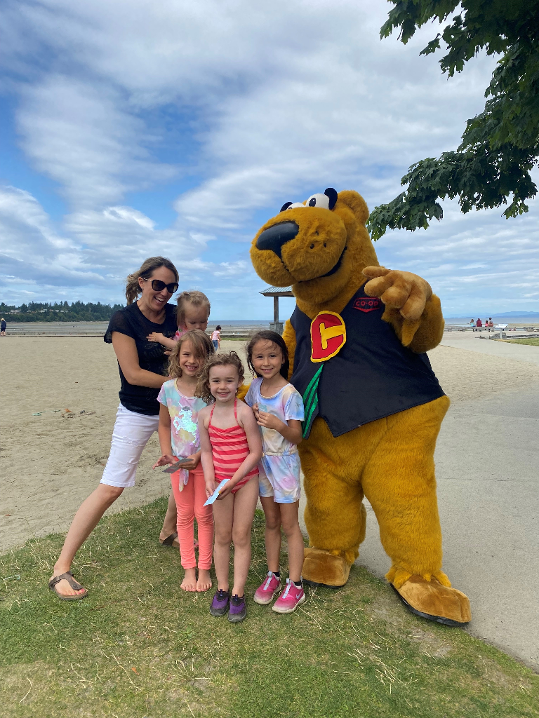 Co-op mascot Cooper with a family